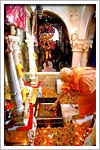 Swamishri reverentially touches the charanarvind