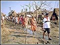 Sadhus and volunteers survey the damage caused by the floods