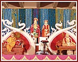 Swamishri on the  decorated stage  during the main Yogi Jayanti assembly