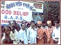 Sadhus and volunteers at a BAPS flood relief outpost