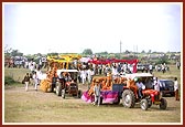 Thakorji was paraded for darshan in a colorful, devotional procession of 40 tractors and floats through the streets and outskirts of Sarangpur village