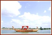 Swamishri performs the maha-puja rituals on the boat-shaped main stage in the middle of river Utavali