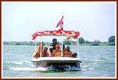 Swamishri with Thakorji and Ganeshji during the ritual five time circumambulatory boat ride in river Utavali 
