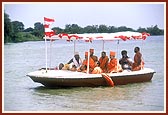 Swamishri and Mahant Swami with Thakorji in the front part of boat