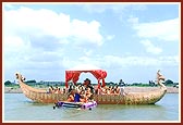 Swamishri bathes Shri Harikrishna Maharaj in the holy waters of Mansarovar on a platform besides the main boat-stage