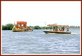 Swamishri with Thakorji and Ganeshji during the ritual boat ride in river Utavali
