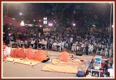 Sadhus perform kirtan aradhana on the beautifully lit up stage by the mandir steps