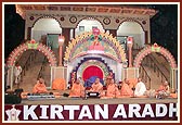 Sadhus perform kirtan aradhana on the beautifully lit up stage by the mandir steps