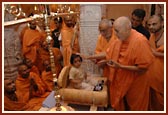Swamishri blessing a child