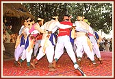 Colorfully dressed tribal youths enthusiastically perform the local Dangi dance 