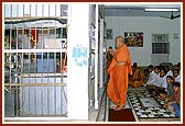 After an exhausting round at the construction site Swamishri stands before the Lord reciting the evening prayers