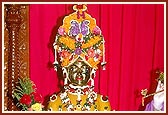 Shri Harikrishna Maharaj adorned in chandan and flowers