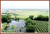 Farms and green landscape with the river Utavali in the background