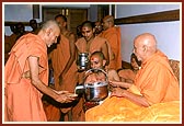 Swamishri first serves dudhpak to Mahant Swami