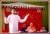 A balak delivers a speech on Children's Day program during puja