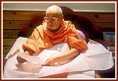 It is time for Swamishri to retire at night, but as usual he is still engrossed in his work