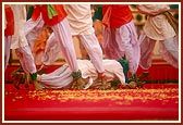 Tribal devotees perform a traditional dance to please Swamishri