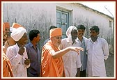 Swamishri on an observation tour around the village mandir