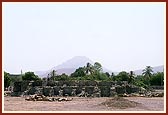 Shikharbaddh mandir under construction at the new site (Mt. Girnar in the background)