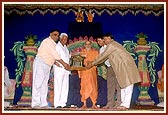 Officials present a plaque of honor to Swamishri 