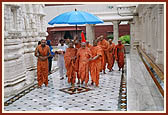 Swamishri doing pradakshina in the rains