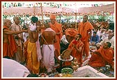 Swamishri ritually presents the yagnopavit to children