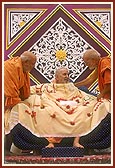 Pujya Ghanshyamcharan Swami and Pujya Hariprakash Swami present a decorated 'chadar' to Swamishri on the occasion of his 53rd Pramukh Varni Din anniversary 