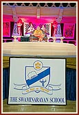 Swamishri attending The Swaminarayan School cultural presentation