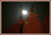 The eclipse visible amongst the pinnacles of Shri Swaminarayan Mandir, London