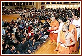 Swamishri showers flowers upon the students