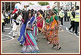 Girls dressed in traditional outfits dance in the Rath Yatra