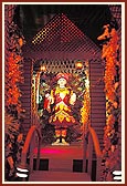 Shri Ghanshyam Maharaj is beautifully adorned with flowers