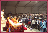 Devotees file pass as Swamishri humbly blesses them after the celebration 
