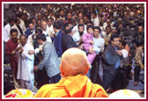 Devotees file pass as Swamishri humbly blesses them after the celebration 