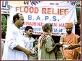Sadhus distribute food to the flood victims