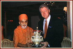 President Clinton is delighted to receive  the 'Amrut Kalash' - Symbol of Auspiciousness from Pramukh Swami Maharaj