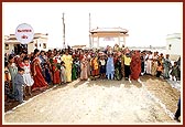 Women of the village make a traditional entrance after the official auspicious opening