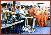 To revive the livelihoods of the earthquake victims Swamishri distributes handcarts, sewing machines and instruments for goldsmiths and cobblers