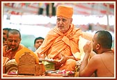Performs arti during the yagna