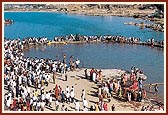 Devotees bathe in the holy river Ghela