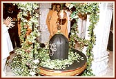 Abhishek of milk and holy water on Shiva-linga arranged beneath the mandir dome