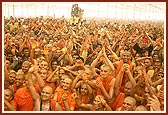 Sadhus enjoy the divine experience of being drenched with the holy water sprayed by Swamishri