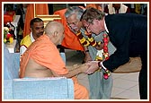 Swamishri greets the ambassador of Netherlands to Tanzania. Mr. Chande introduces  him to Swamishri