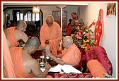 Swamishri serves dhudhpak to Doctor Swami on the occasion of Shastrji Maharaj's shraddh