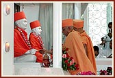 Pujya Doctor Swami and Pujya Viveksagar Swami perform the murti-pratishtha of Shastriji Maharaj and Pramukh Swami Maharaj