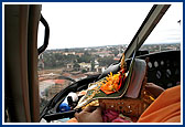 Shri Harikrishna Maharaj blesses the Bhakti Yatra procession during a helicopter trip