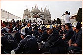 Devotees seated in special T-shirts and caps eagerly awaiting the start of the Walk