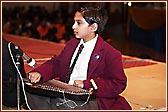 A student demonstrates his learning of Indian classical instruments