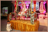 Murti of Shreeji Maharaj placed on a beautifully decorated swing