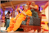 Ghanshyamcharan Swami plays the kartals with Swamishri
